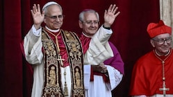 Newly elected Pope Leo XIV, Robert Prevost (L) gestures as he arrives on the main central loggia balcony of the St Peter's Basilica for the first time, after the cardinals ended the conclave, in The Vatican. (IMAGE: AFP)